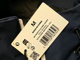 a tag on the back of a blue jacket