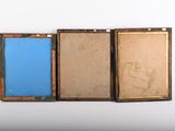 three pieces of art that are sitting on a table