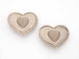 pair of silver heart shaped earrings on a white background