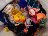 a bag full of clothes that is sitting on a bed