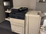 a photo of a printer sitting on a desk in a room
