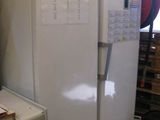 a white refrigerator and a white refrigerator freezer in a room
