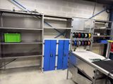 a kitchen with a sink, shelves, and a stove in it