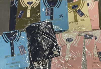 a lot of t - shirts that are wrapped in plastic