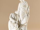 statue of a woman kneeling down with a child on her lap