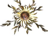 a picture of a metal sunburst on a white background