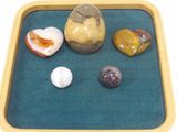 a tray that has rocks and eggs on it
