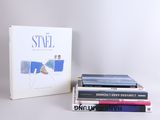 several books are stacked on top of each other on a table