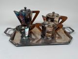 a silver tray with a silver coffee pot and a silver tea pot on it