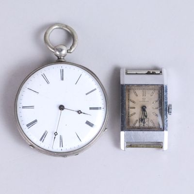 a silver pocket watch and a silver watch on a white surface
