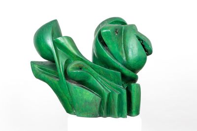 sculpture of a frog made of green marbles on a white pedestal