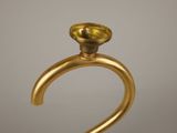 gold plated candle holder with a glass candle on top of it
