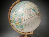 an old globe with a wooden stand and a black background