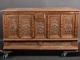 an old wooden chest sitting on top of a dolly dolly