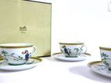 three cups and saucers sitting on a table
