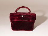 burgundy velvet handbag with rope handle on white background