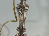 a silver lamp that is on a table