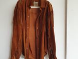 veste marron à franges suspendue à un cintre
