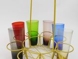 six glasses in a basket on a white surface