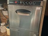 a stainless steel dishwasher in the corner of a kitchen