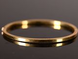 a close up of a gold ring on a black surface