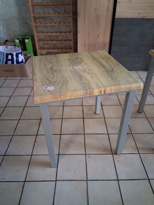 a small table with a wooden top on a tiled floor