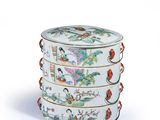 a white container with a design of birds and flowers