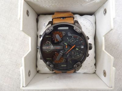 a watch that is in a box on the floor