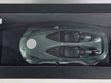 a green toy car in a box on a table