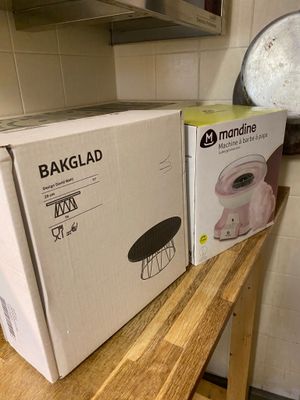 two boxes of bread sit on a wooden counter in a kitchen