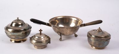 four pieces of silverware on a white surface