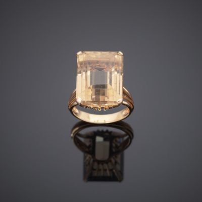 an 18k yellow gold ring set with an emerald stone
