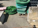 a pile of green plastic containers sitting on the ground
