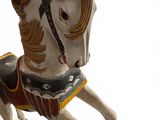 a toy horse that is standing on a white surface