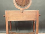 a small wooden table with a mirror on top of it