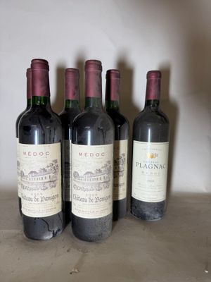 four bottles of red wine are lined up in a row