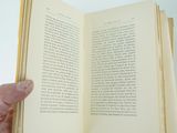 a person holding an open book in their hand