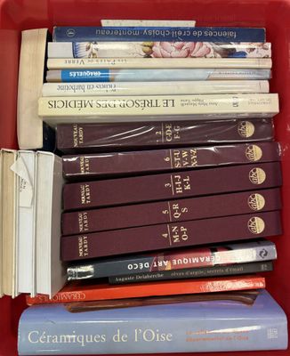 many books in a red box on the table