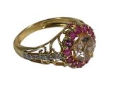 an image of a gold ring with a pink stone and diamonds