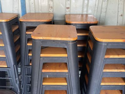 many stools that are stacked on top of each other