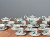a table with a lot of tea and coffee cups and saucers