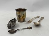 a cup, spoon, and spoon rest on a table