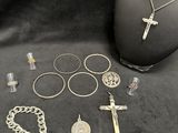 a lot of silver jewelry on a black cloth