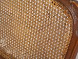 a wooden bench with a wicker back and a wooden seat