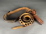 a brown leather belt with a flower on it