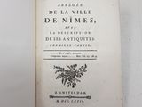 an old book sitting on top of a table next to a white wall