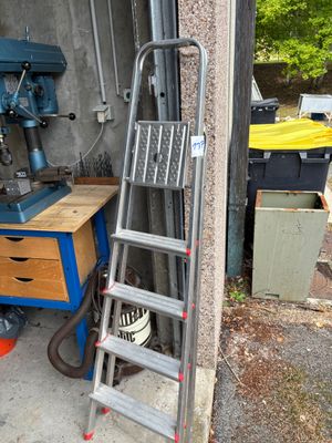 a ladder leaning up against a wall next to a table