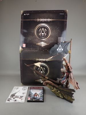 assassin origins collector ' s box with a statue of a man holding a spear and a sword