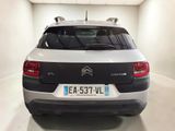 the back of a white and black citrole car parked in a garage