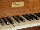 a close up of a piano keyboard with a plaque on it